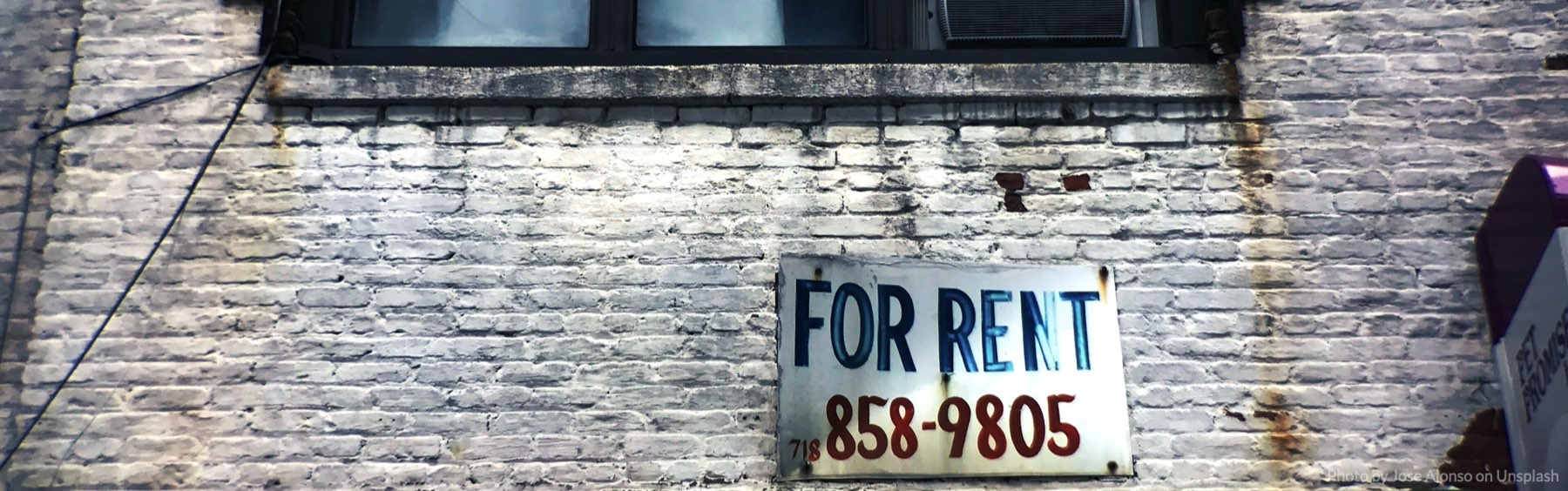 For rent sign on apartment building